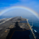 Illustration for article titled Check Out This Shot Of A Super Carrier Passing Through A Rainbow